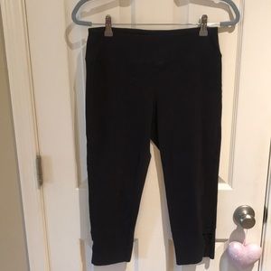Black MNY crop yoga pants size M, with slash opening at bottom of each leg.